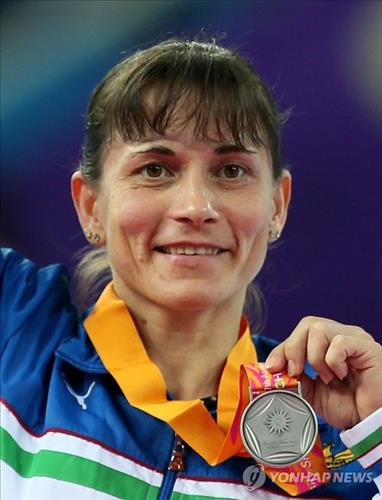Uzbekistan&#39;s <b>Oksana Chusovitina</b>, 39, holds up her silver medal following the ... - AEN20140925008700315_01_i