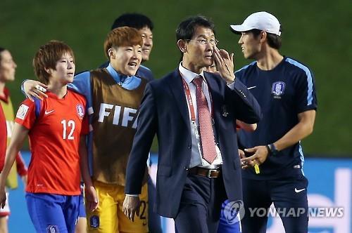 South Korea head coach Yoon Duk-yeo (second from right in suit) wipes away tears after his team defeated Spain 2-1 to clinch a knockout berth at the FIFA Women's World Cup in Ottawa on June 17, 2015. (Yonhap)'/><br/><br/>   South Korea got some lucky breaks in Wednesday's match to set up the showdown against France. With the score tied at 1-1, Kim Soo-yun floated what appeared to be a cross from the right wing, but it somehow sailed over goalkeeper Ainhoa Tirapu and into the far corner for the winner.<br/><br/>   Then with the clock ticking down, Spain's Sonia Bermudez had her free kick go off the crossbar in the match's final play. A draw would have knocked both Spain and South Korea out of the tournament.<br/><br/>   Yoon said he never lost faith in his players even after they went down early.<br/><br/>   