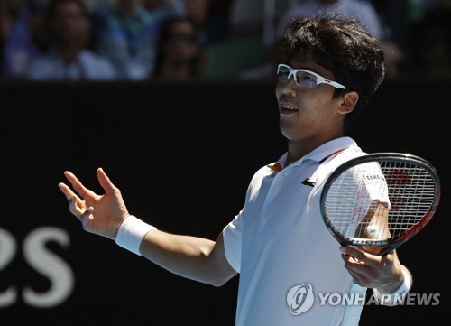 In this photo taken by the Associated Press on Jan. 24, 2018, South Korean tennis player Chung Hyeon reacts after winning a point against the United States' Tennys Sandgren during their quarterfinal match at the Australian Open in Melbourne, Australia. (Yonhap)