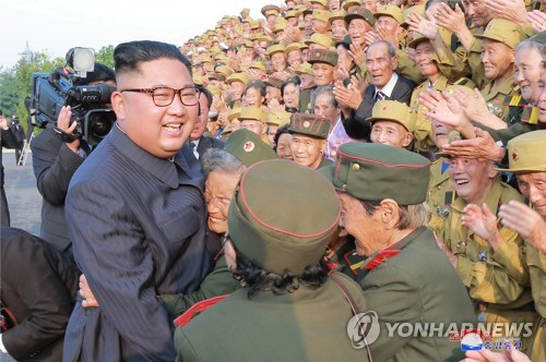 노병대회 참가자들과 기념촬영하는 김정은